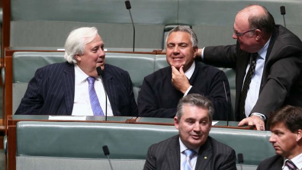Palmer United Party leader Clive Palmer and Treasurer Joe Hockey in discussion during a division in the House of Representatives on Monday evening. Photo: Alex Ellinghausen
