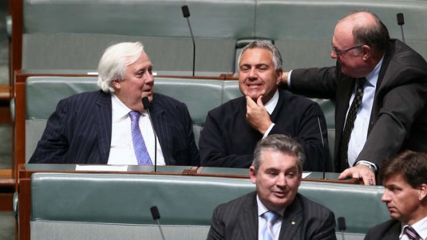 Palmer United Party leader Clive Palmer and Treasurer Joe Hockey in discussion during a division in the House of Representatives on Monday evening. Photo: Alex Ellinghausen