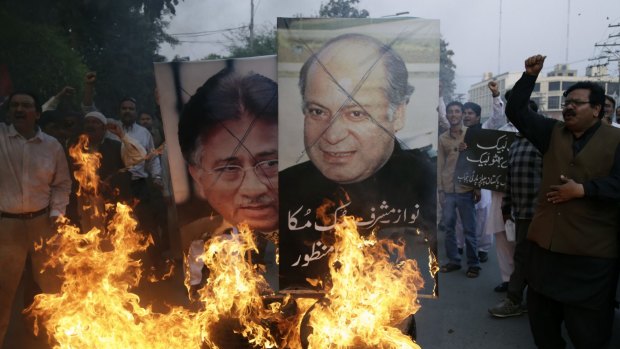 Protesters burn pictures of Pakistani political leaders past and present in Lahore before this week's attack. Pakistan has become a bitterly divided nation.