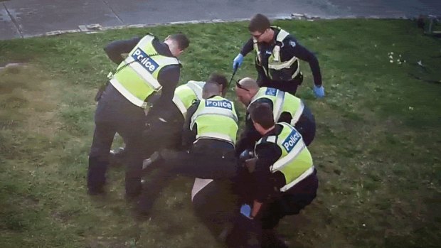 An image from CCTV showing police pinning pensioner John to the ground.