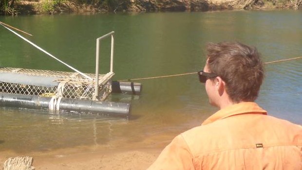 At Taylors Park boat ramp on Monday, four Quintis workers helped the rangers pull in the saltie from the trap.