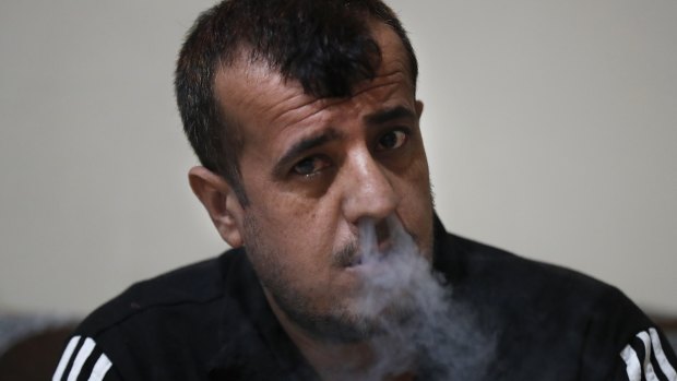 Abdullah Khalaf, 35, a Syrian former IS member smokes, at a Kurdish-run prison in Qamishli, north Syria. 