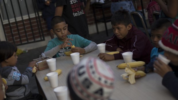 Children have their breakfast at the "Vina de Tijuana AC" migrant shelter in Tijuana, Mexico.