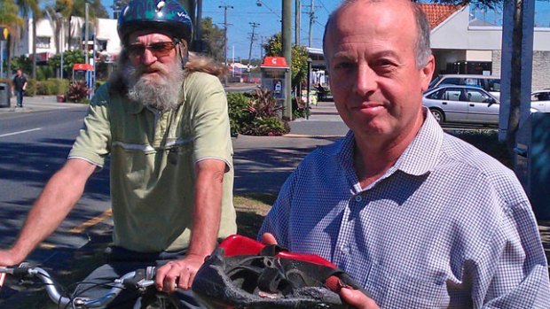 Councillor Kim Flesser, pictured in 2013, holding the helmet he claims saved his life in a cycling accident a decade earlier