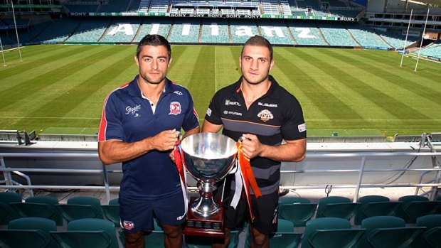 Old foes &#8230; Roosters captain Anthony Minichiello and Wests Tigers captain Robbie Farah with the Foundation Cup trophy their teams will play for on Saturday.