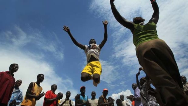 Referendum . . . a member of the Agaar Marol jumping group leaps into the air in Juba, cheered on by supporters of independence for South Sudan.