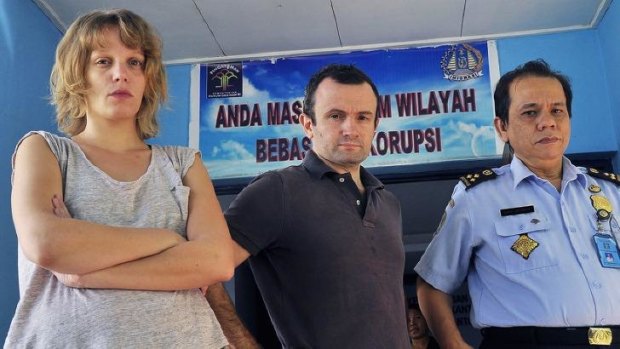 French journalists Thomas Dandois (centre), 40, and Valentine Bourrat (left), 29, from Franco-German television channel Arte are photographed with an unidentified Indonesian immigration official in Jayapura city in Papua province.