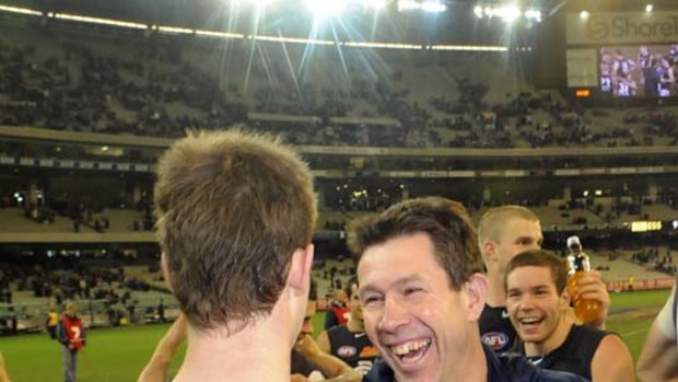 Carlton coach Brett Ratten, after a week from hell, celebrates last night's win over Essendon with young gun Bryce Gibbs.