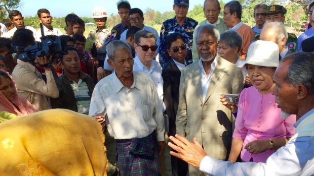 Former UN secretary-general Kofi Annan, third from right, speaks to Rohingya villagers during a visit to Rakhine state in December. 