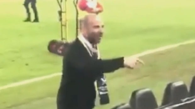George Calombaris exchanges words with a fan at the A-League grand final.