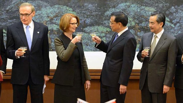 Australia's Prime Minister Julia Gillard shares a toast with Chinese Premier Li Keqiang during a signing ceremony at the Great Hall of the People in Beijing.