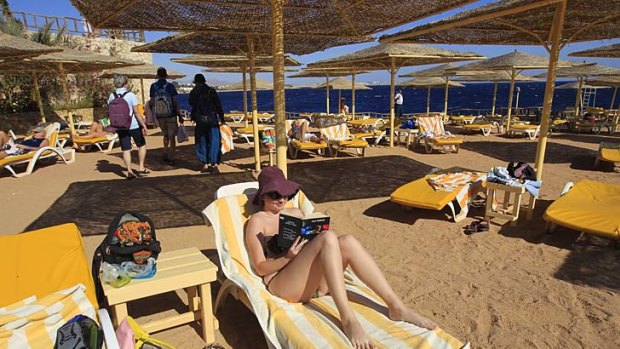 A bikini-clad tourist reads a book at the beach of the Red Sea resort town of Sharm el-Sheikh, Egypt. Tourism officials have sought to reassure tourists travellers about the future of the country as a holiday destination, despite fears of a crackdown on the sale of alcohol and calls for segregated beaches.