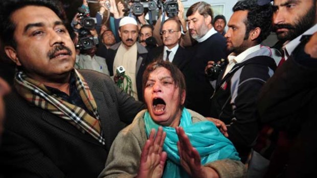 A distraught supporter of the Pakistan People's Party after the assassination of Punjab governor Salman Taseer.