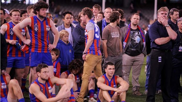 Bitter pill: Port Melbourne players and coach Gary Ayres after the grand final loss.