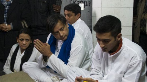 Shashi Tharoor sits beside  the body of his wife Sunanda Pushkar at a cremation centre in New Delhi.