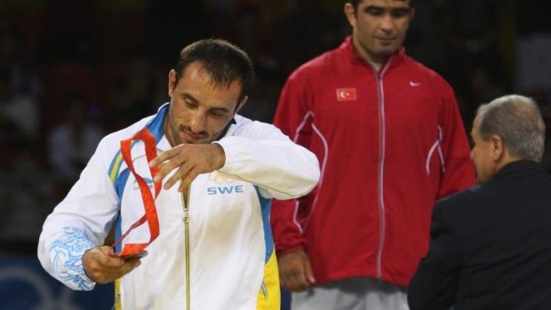 Ara Abrahamian storms off the podium at the Beijing Olympics.