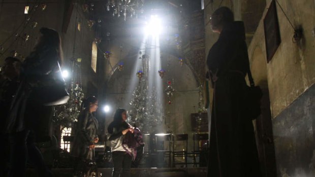 Under pressure &#8230; a Christian monk and two worshippers in the Church of the Nativity in Bethlehem, traditionally believed to be Christ's birthplace.