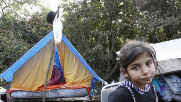 Homeless ... a Roma girl outside a makeshift tent after police removed the family’s caravan at an illegal camp near Lille.