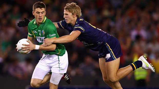 Eoin Cadogan of Ireland is tackled by Trent McKenzie of Australia during game one of the International Rules Series at Etihad Stadium last night.