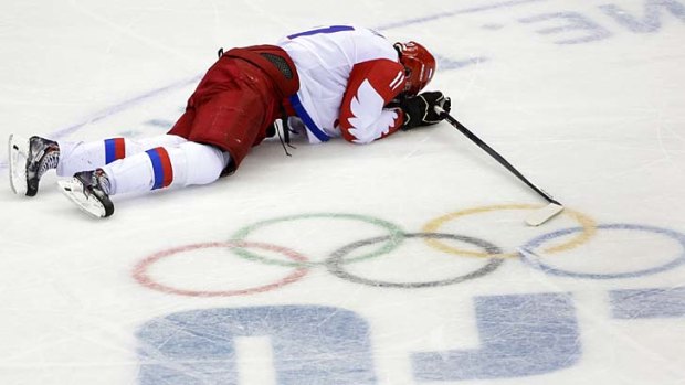 Down and out: Russia forward Yevgeni Malkin lies on the ice in the closing minutes of the match.