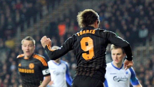 Chelsea's Fernando Torres jumps over FC Copenhagen goalkeeper Johan Wiland.