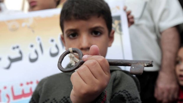 Raw history ... a Palestinian boy at a protest in Khan Yunis carries a key, symbolising the homes left by Palestinians in 1948.