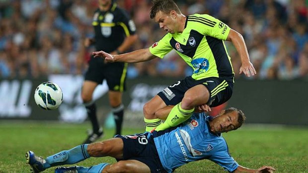 Down under: Sydney's Joel Griffiths tackles Victory's Daniel Mullen at Allianz Stadium.
