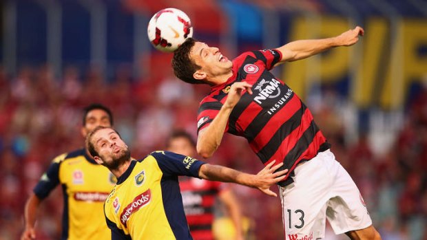 Leading from the back: Matthew Spiranovic outleaps Marcel Seip of the Mariners during the Wanderers' 2-0 win at Parramatta Stadium.