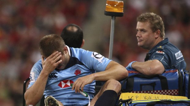 Down but not out &#8230; Drew Mitchell is taken from the field after breaking his ankle against the Reds earlier this year.