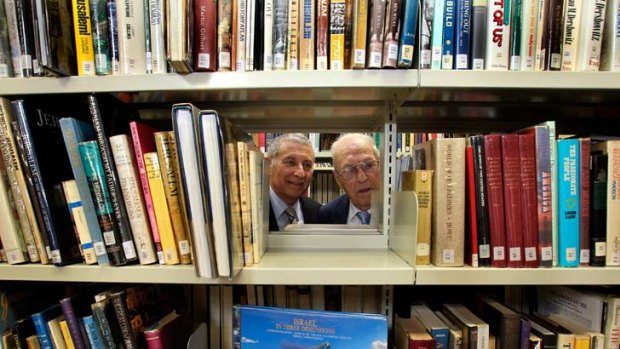 Danny Lamm, left, and father Erwin, inspect some of the 70,000 volumes in the new Lamm Jewish Library of Australia.