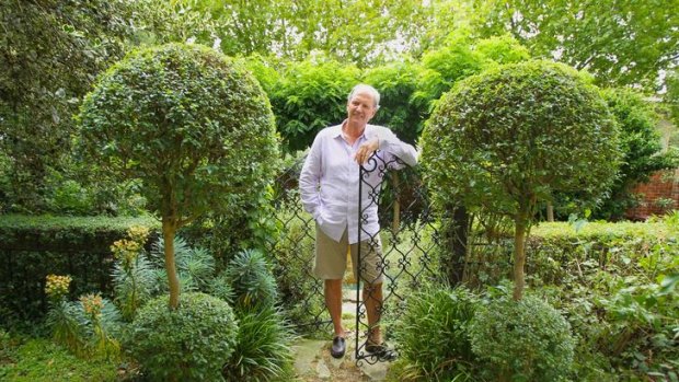 David Wilkinson in his South Yarra garden; a honeysuckle climbs a wall of his house.