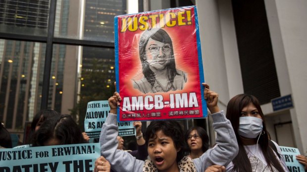 A supporter holds up a sign with a drawing of Indonesian domestic helper Erwiana Sulistyaningsih during a protest calling for better protection of migrant workers in Hong Kong.