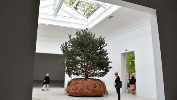 Visitors admire one of the three mobiles trees in French artist Celeste Boursier-Mougenot's work.