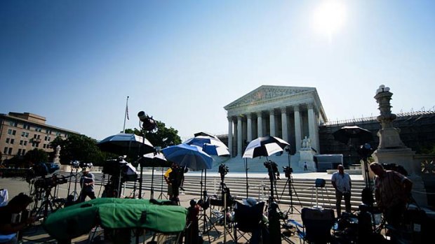 Members of the media camp outside the US Supreme Court ahead of its historic ruling on Barack Obama's healthcare legislation.