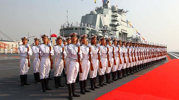 Naval honour guards stand awaiting a review on China's aircraft carrier Liaoning.