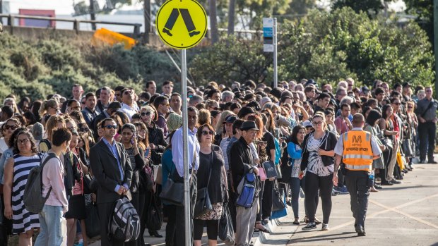 Hundreds of train passengers wait for buses at Watergardens station after trains were suspended between Albion and Footscray stations.