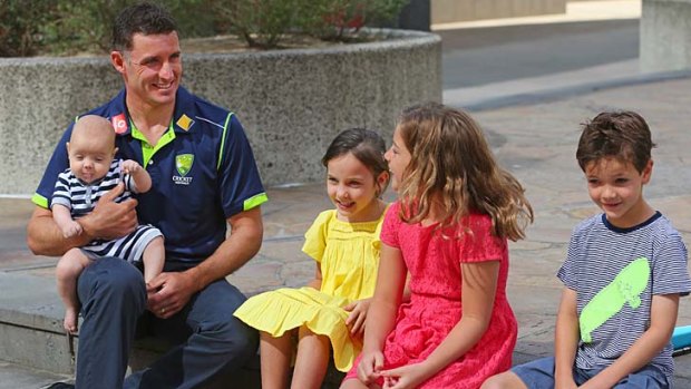Michael Hussey of Australia holds his son Oscar as he talks to his daughters Jasmin and Molly and son William after Sunday's retirement press conference.
