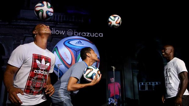 New ball for the World Cup: Cafu, Hernane and Clarence Seedorf juggle the Brazuca.