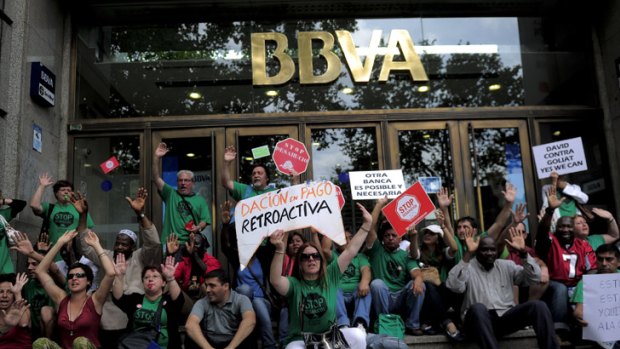 Young Spaniards protest in front of a bank office in Barcelona. More than half of the nation's 15 to 24-year-olds are unemployed and 37 per cent of those aged 25 to 34 live with their parents.
