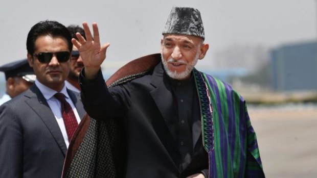 Afghanistan President Hamid Karzai waves on his arrival.