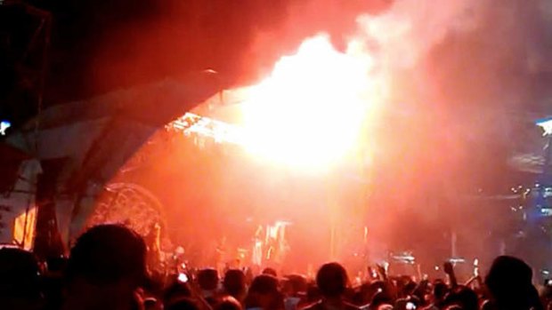Police confirmed a flare was fired near stage three and three people were treated for burns.