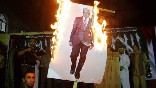 Anger ... Palestinians in the Jabaliya Refugee Camp, northern Gaza, burn a picture of Mahmoud Abbas in a protest against his comments.