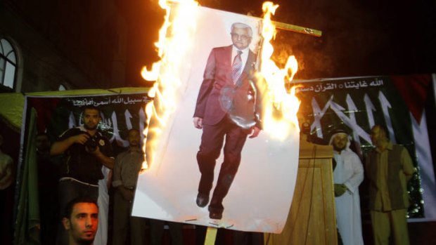 Outrage ... Palestinians in the Jabaliya Refugee Camp, northern Gaza, burn a picture of Mahmoud Abbas in a protest against his comments.