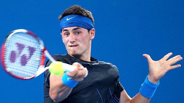 Bernard Tomic secures a semi-final showdown with Scot Andy Murray after disposing of Denis Istomin of Uzbekistan.