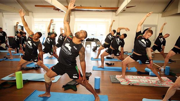 Reach for the sky: Roy Asotasi stretches in a yoga session with the Rabbitohs on Monday.