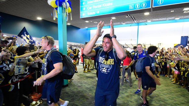 Highs and lows: Cowboys star Jason Taumalolo waves to the crowd after arriving back in Townsville after the grand final.
