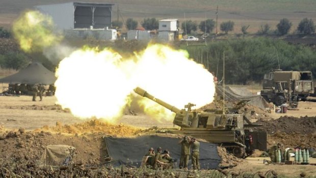 An Israeli canon fires towards the Gaza Strip from the border.