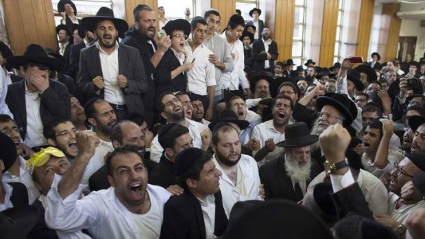 Ultra-Orthodox Jewish men recite prayers near the body of Rabbi Ovadia Yosef, the spiritual leader of the ultra-religious Shas political party, before his funeral at a seminary in Jerusalem.