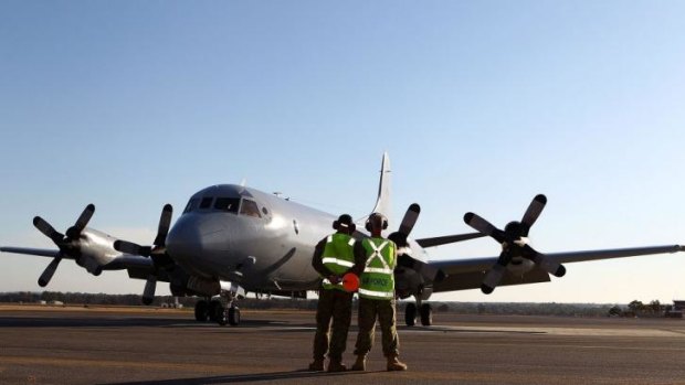 RAAF ground crew stand on the apron after an AP-3C Orion returns from a search mission for MH370 debris in Perth on Thursday. 