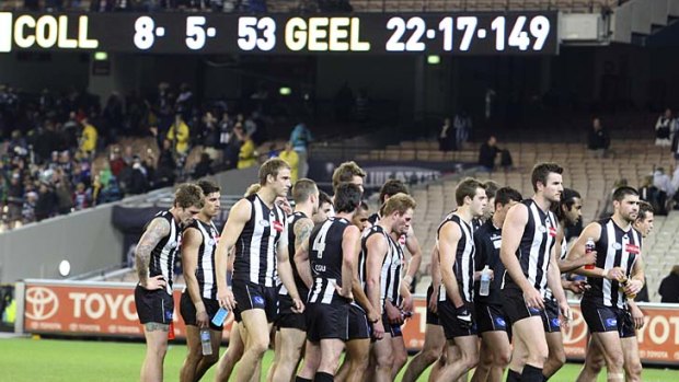The score's on the board: Collingwood players leave the field last night.
